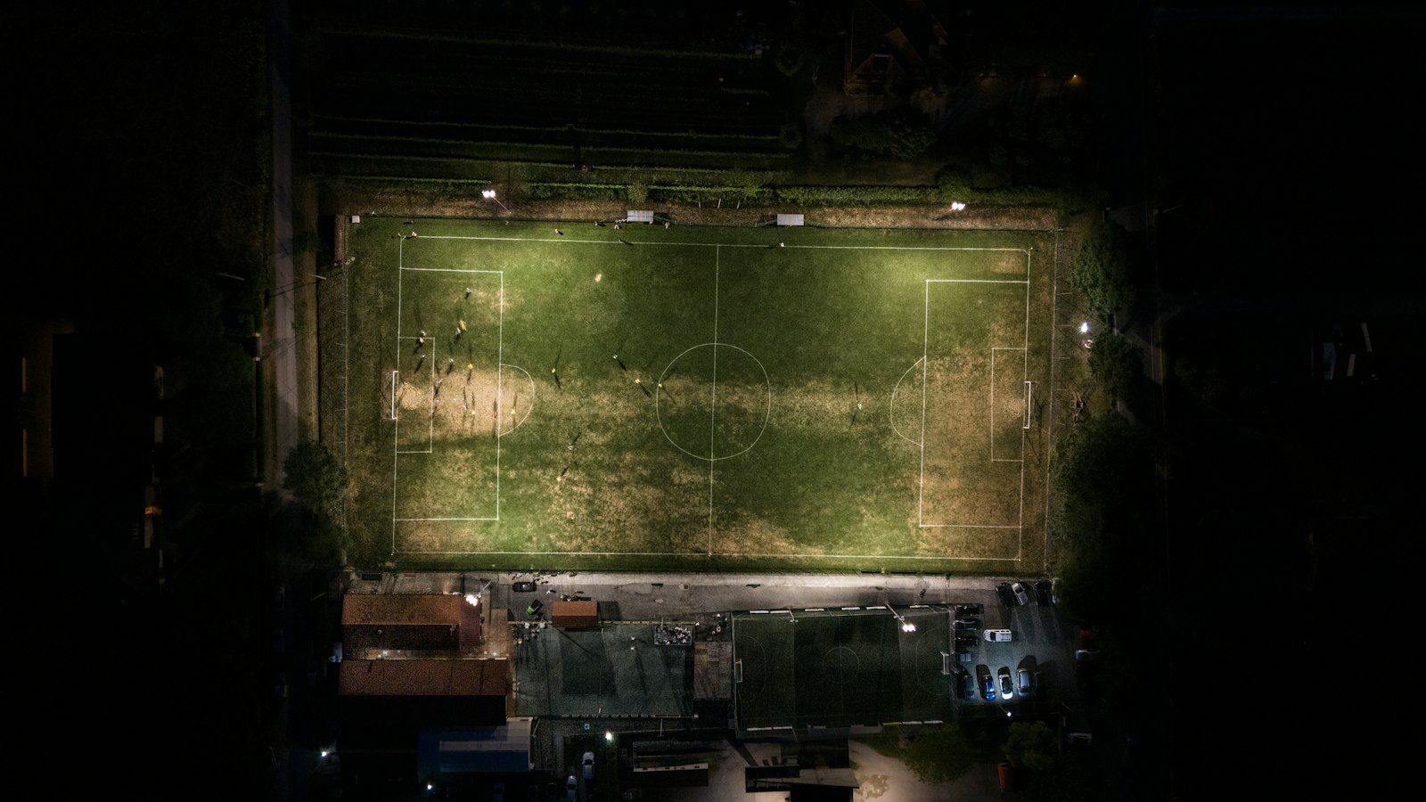 Cancha de fútbol iluminada de noche, vista aérea